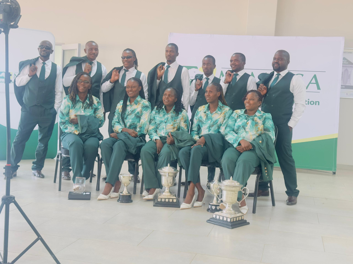 Our People Sitting with trophy